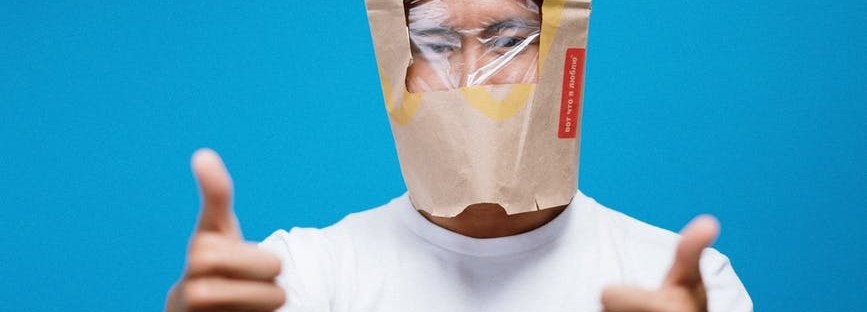 Guy with McDonald's paper back with window cut out over his eyes